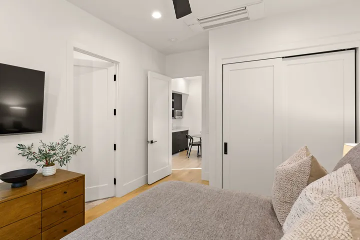 Bedroom featuring light wood finished floors, recessed lighting, and a closet