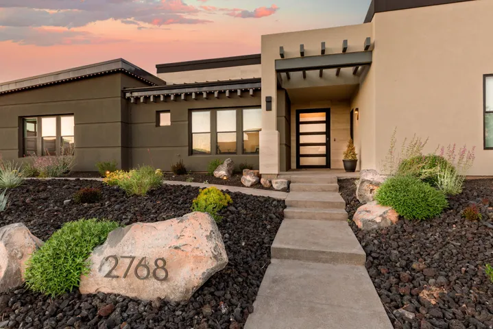 Exterior entry at dusk with stucco siding