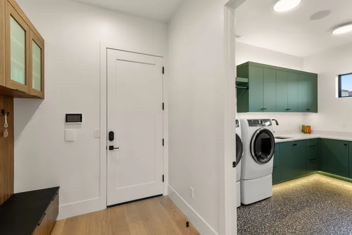 Laundry room with baseboards and cabinet space