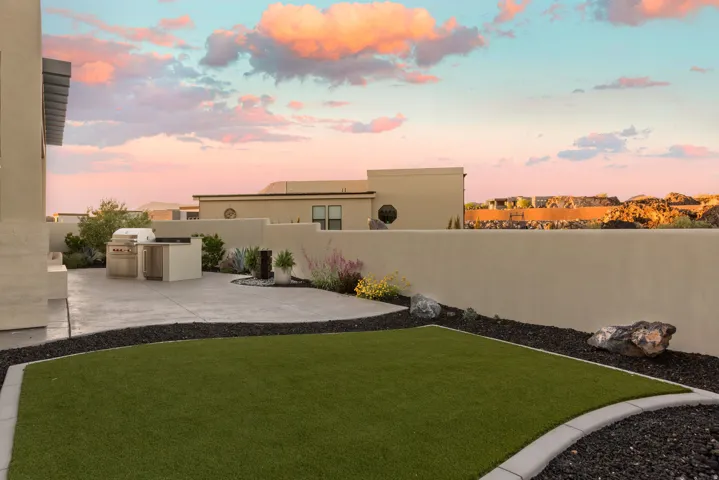 Fenced yard featuring area for grilling and a patio area