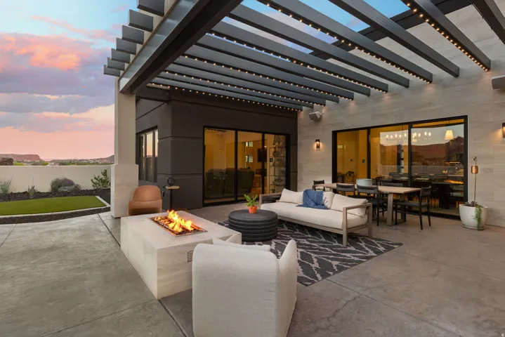 Patio terrace at dusk featuring a pergola, a patio area, outdoor lounge area, and a fire pit