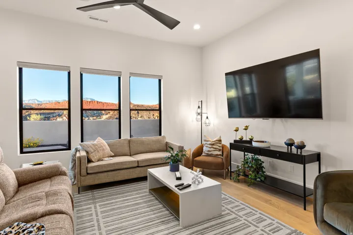 Living area featuring a ceiling fan, light wood-type flooring, and recessed lighting