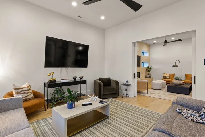 Living area with light wood finished floors, recessed lighting, and ceiling fan
