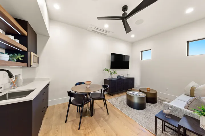 Living area featuring light wood finished floors, recessed lighting, and ceiling fan