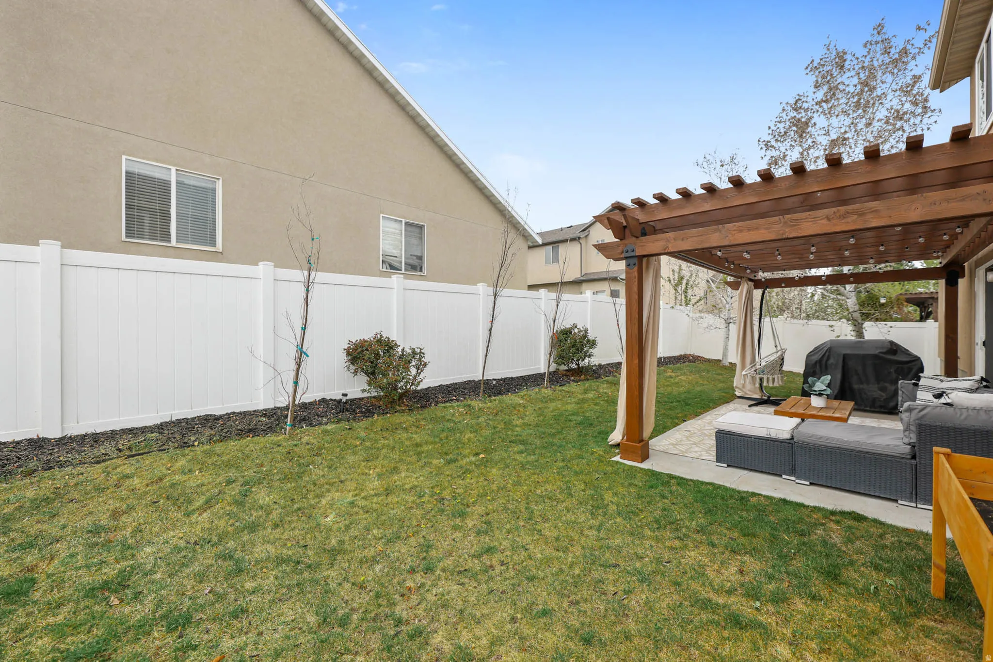 Fenced backyard featuring a pergola, a patio, and outdoor lounge area