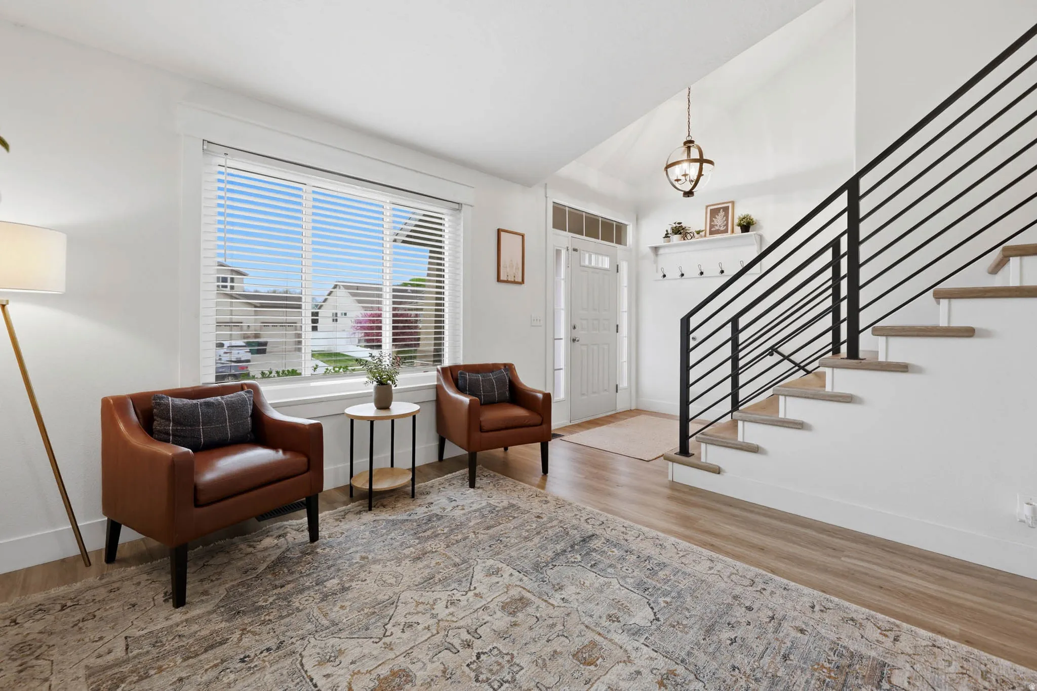 Entrance foyer featuring lofted ceiling and light wood finished floors