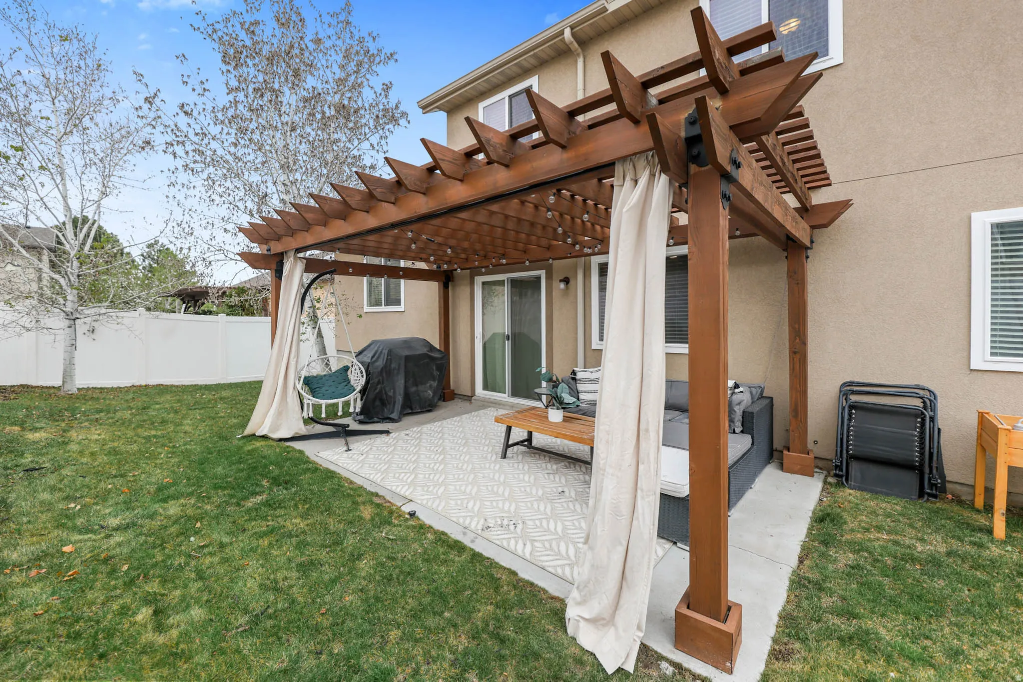View of patio with a pergola and a grill