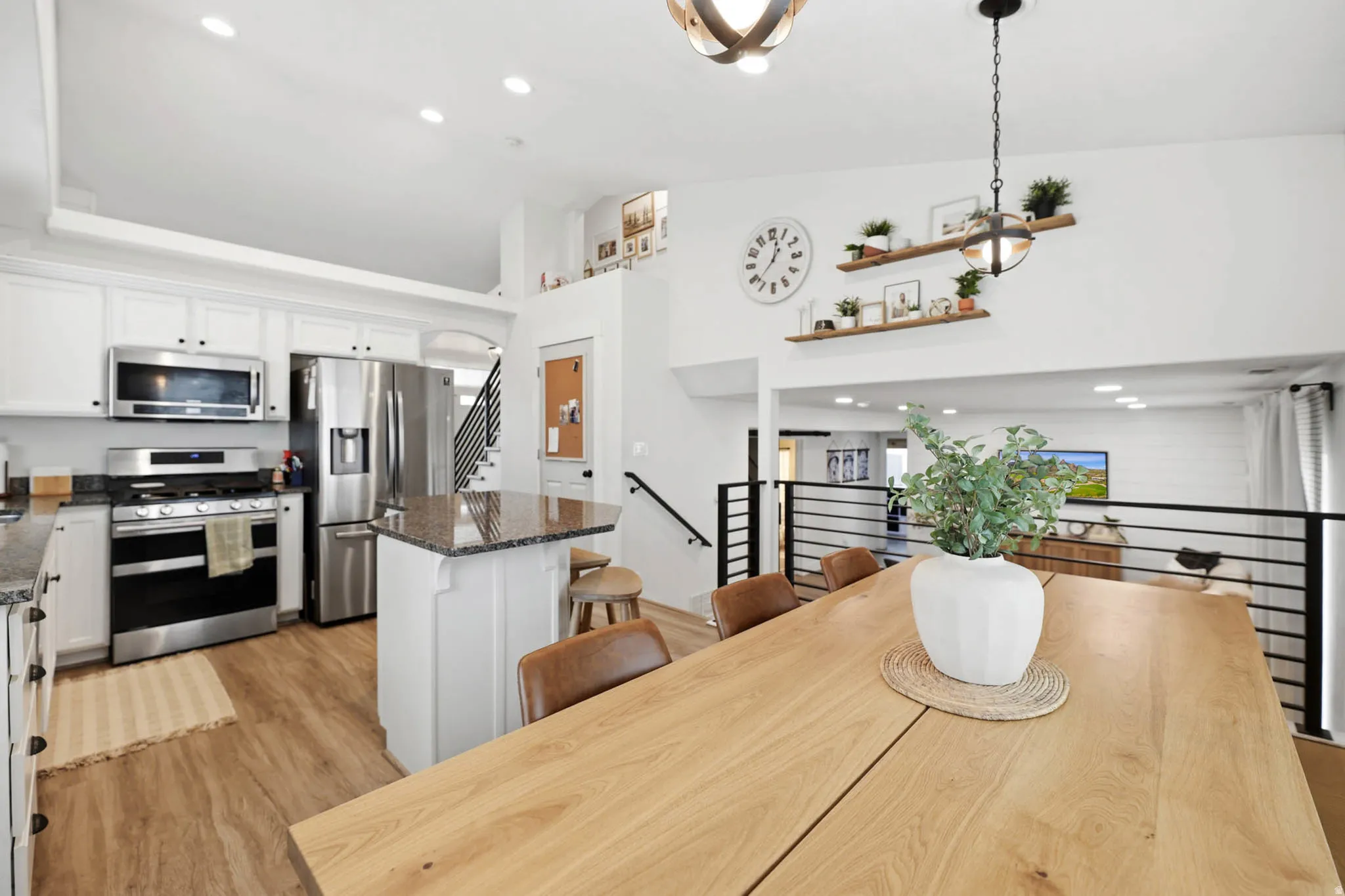 Dining space with recessed lighting, light wood-style flooring, and vaulted ceiling
