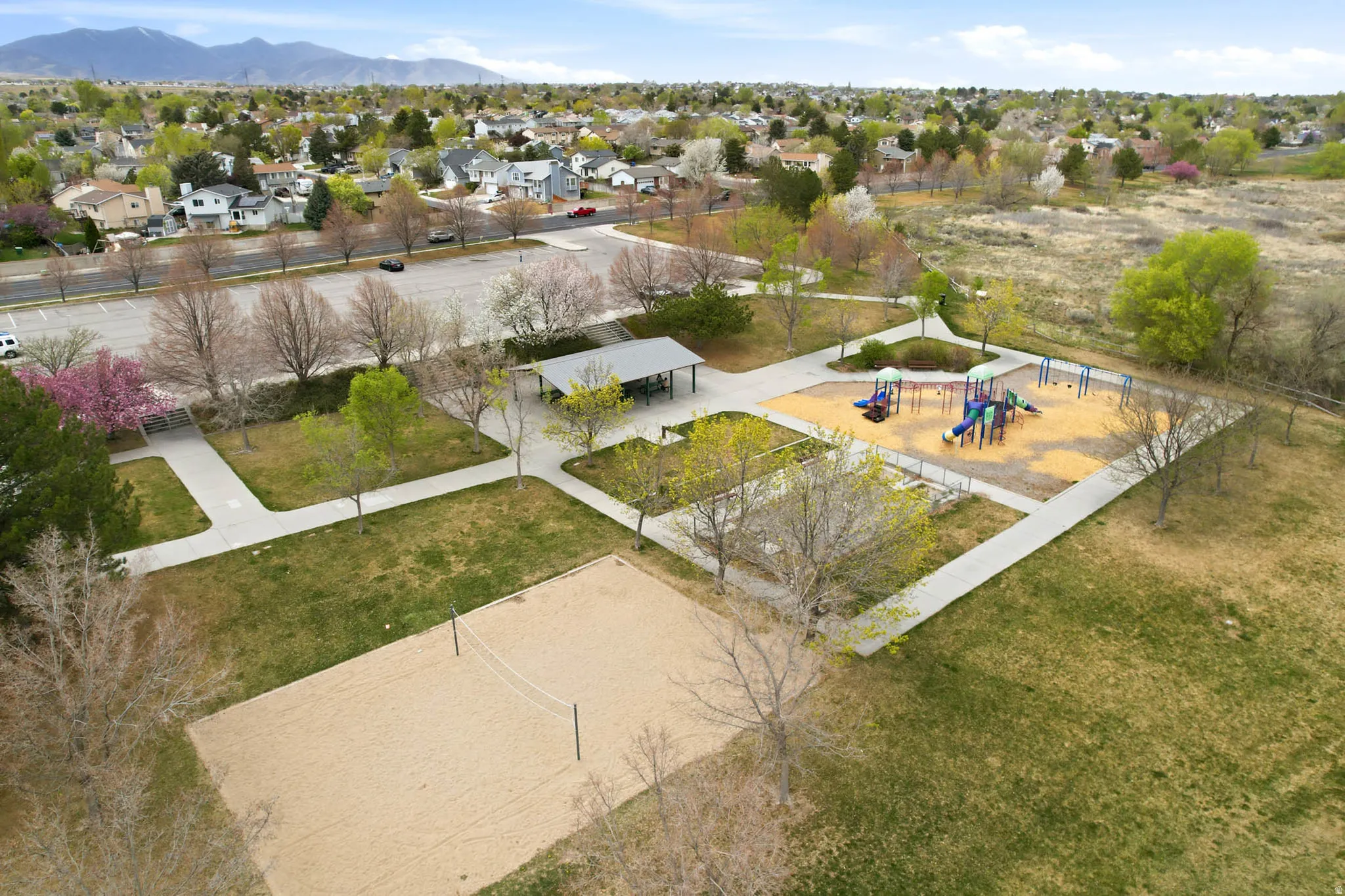 Aerial view of residential area with a park and a mountainous background