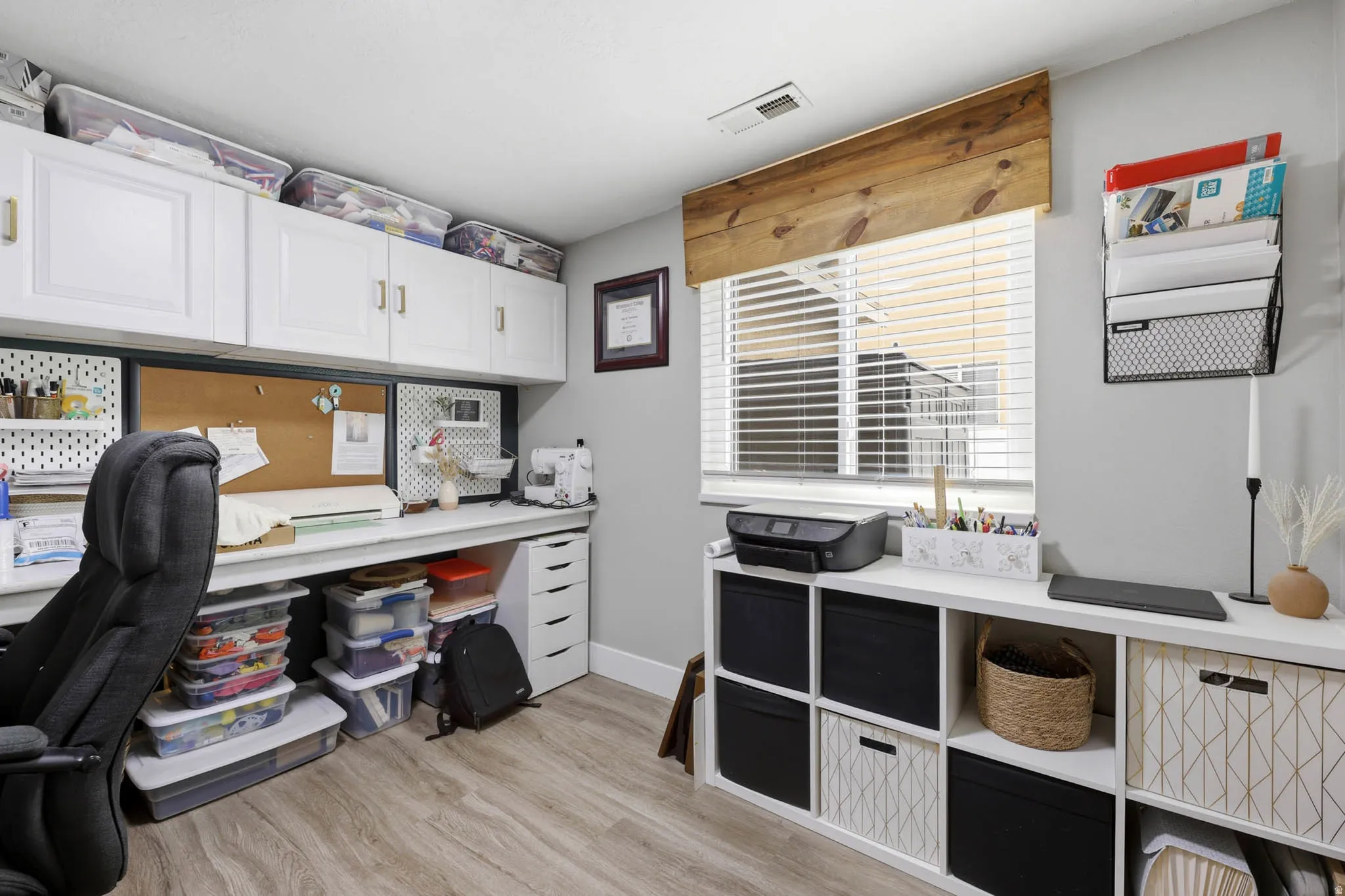 Office space with light wood-style flooring and baseboards