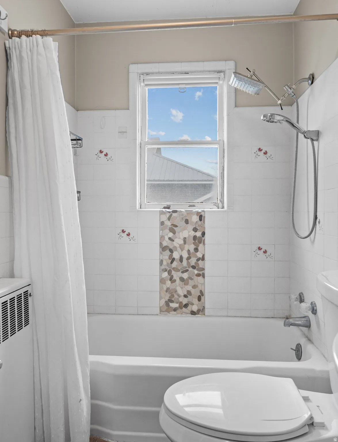 Bathroom featuring toilet and shower / tub combo