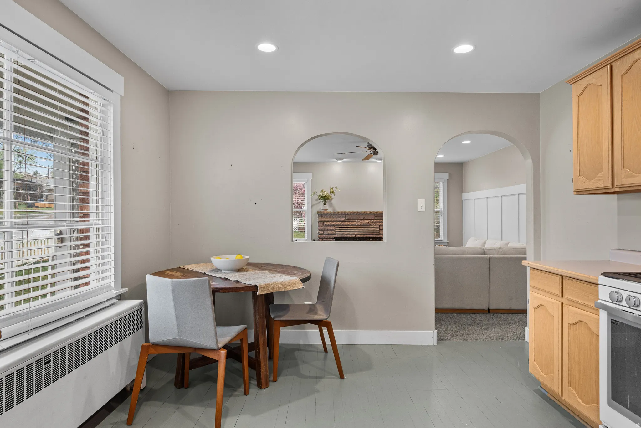 Dining room featuring radiator, recessed lighting, and arched walkways