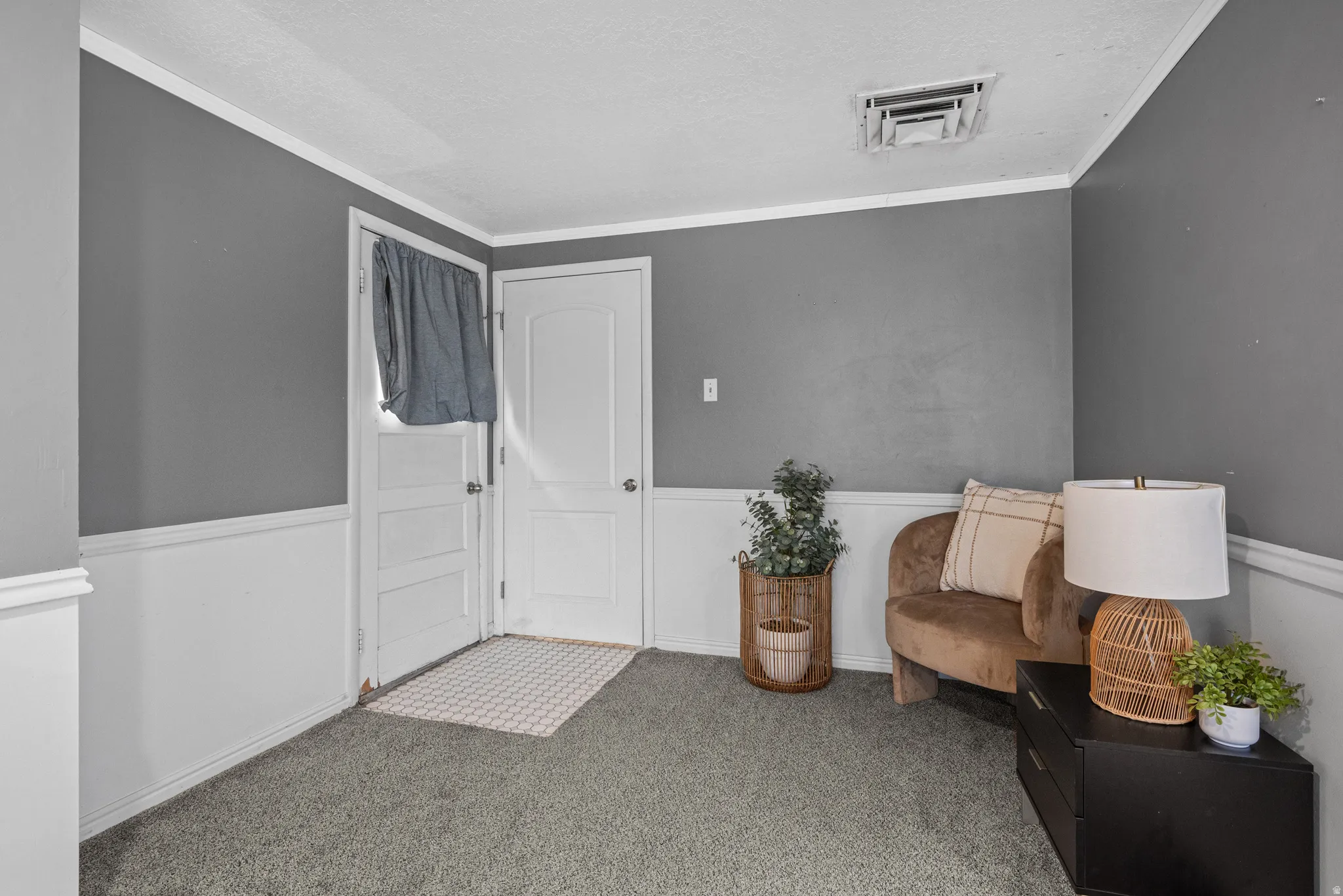 Living area with carpet flooring and ornamental molding