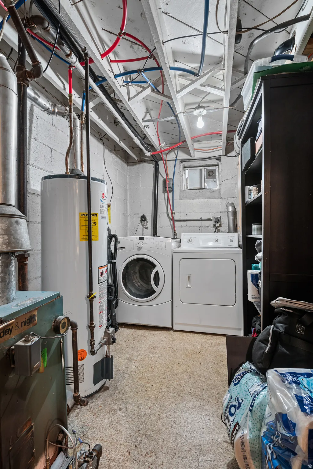 Laundry area with gas water heater and independent washer and dryer