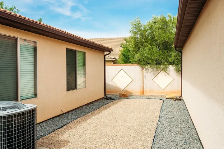 View of property exterior with a central AC unit and stucco siding