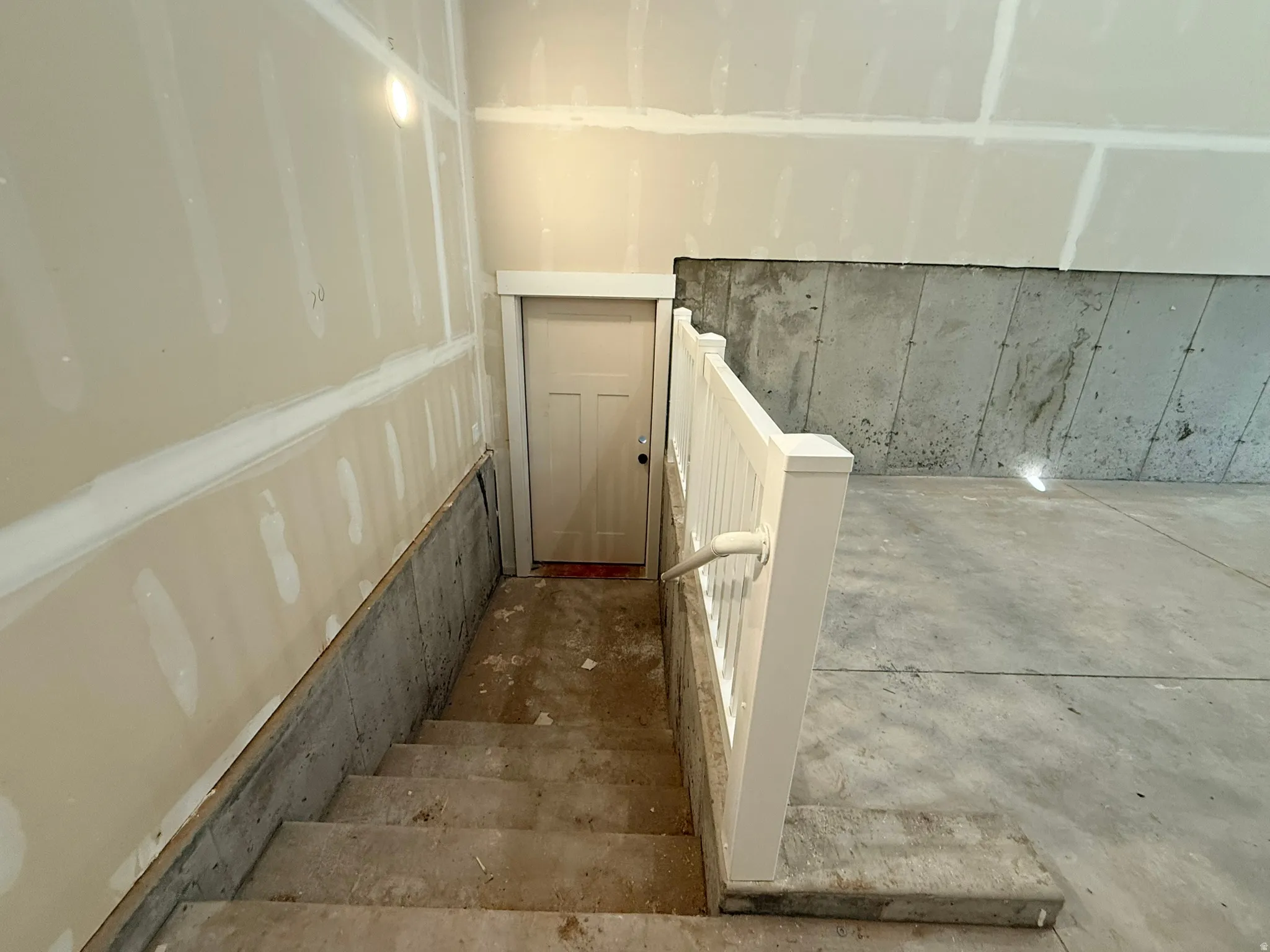 Stairs featuring concrete floors