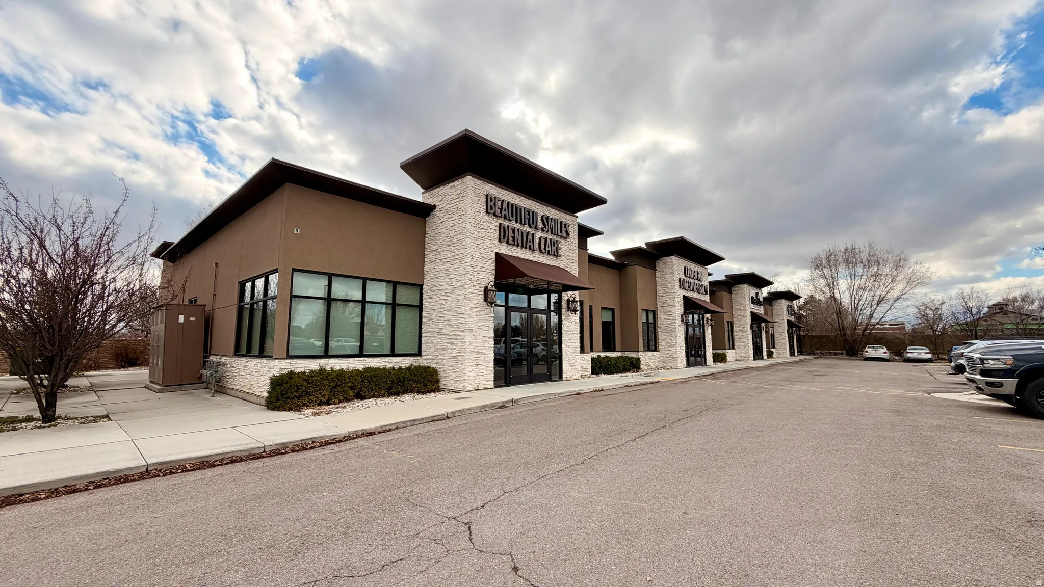 View of commercial property with uncovered parking