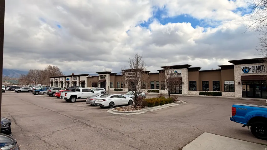 View of commercial property with uncovered parking