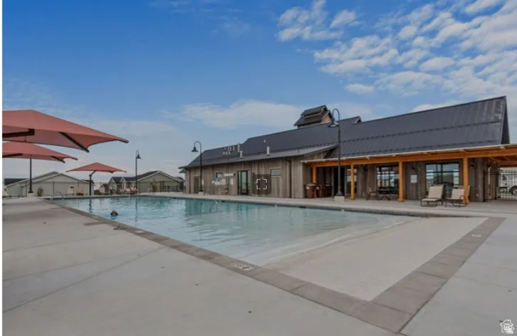 Community pool with a patio