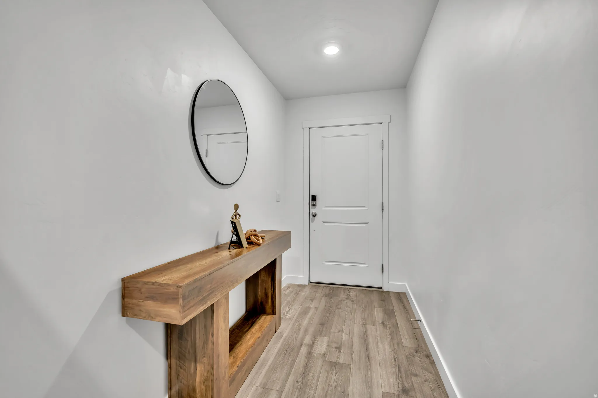 Entryway with wood finished floors and baseboards