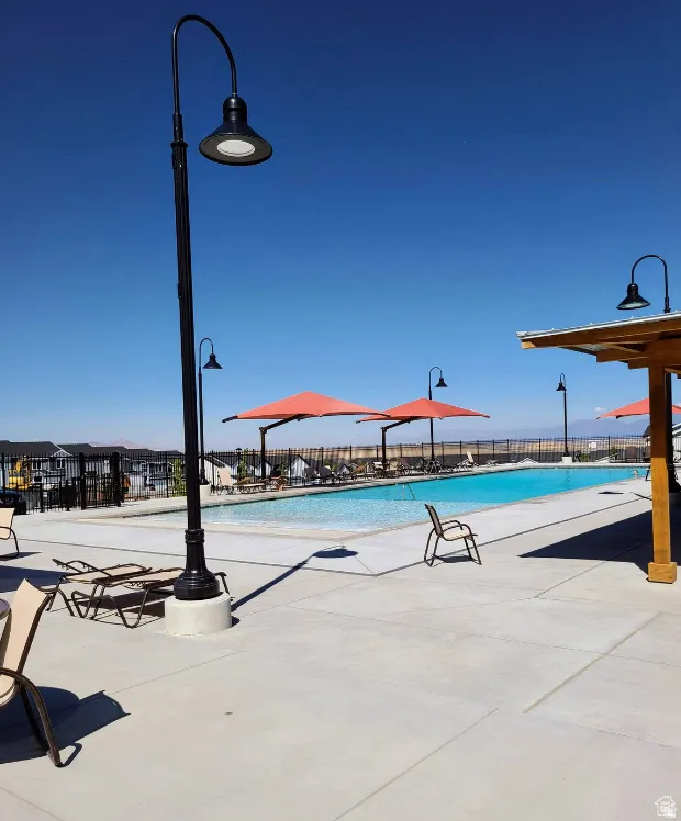 Community pool with a patio