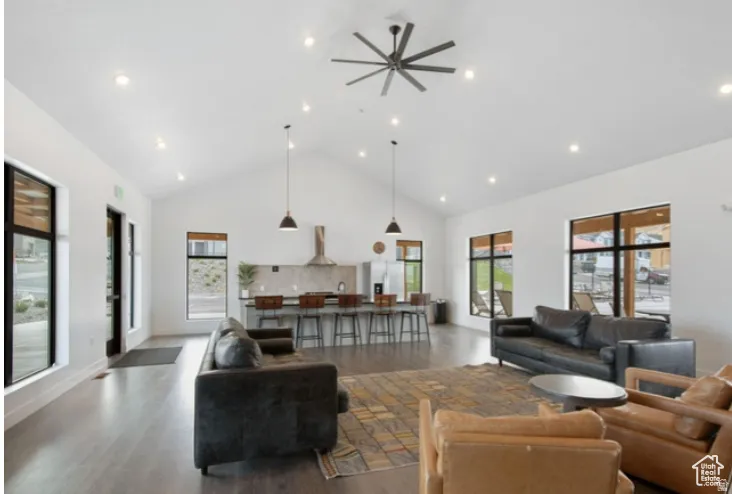 Clubhouse with a high ceiling, wood finished floors, a ceiling fan, and recessed lighting