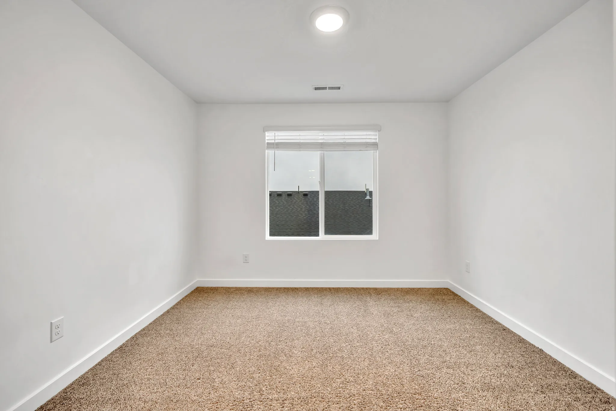 Bedroom 2 featuring baseboards and light colored carpet