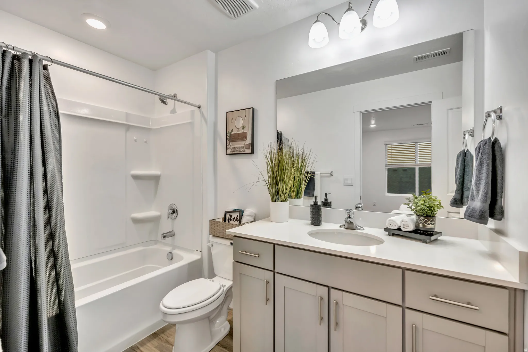 Full master bath featuring vanity, shower / bath combo, recessed lighting, and light wood-style floors