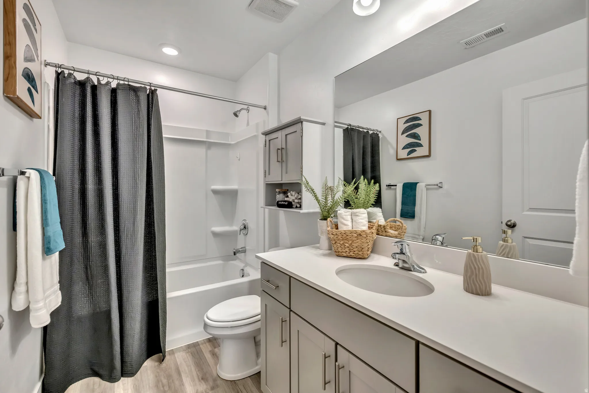 Full bath #2 featuring vanity, light wood-style flooring, and shower / bath combination