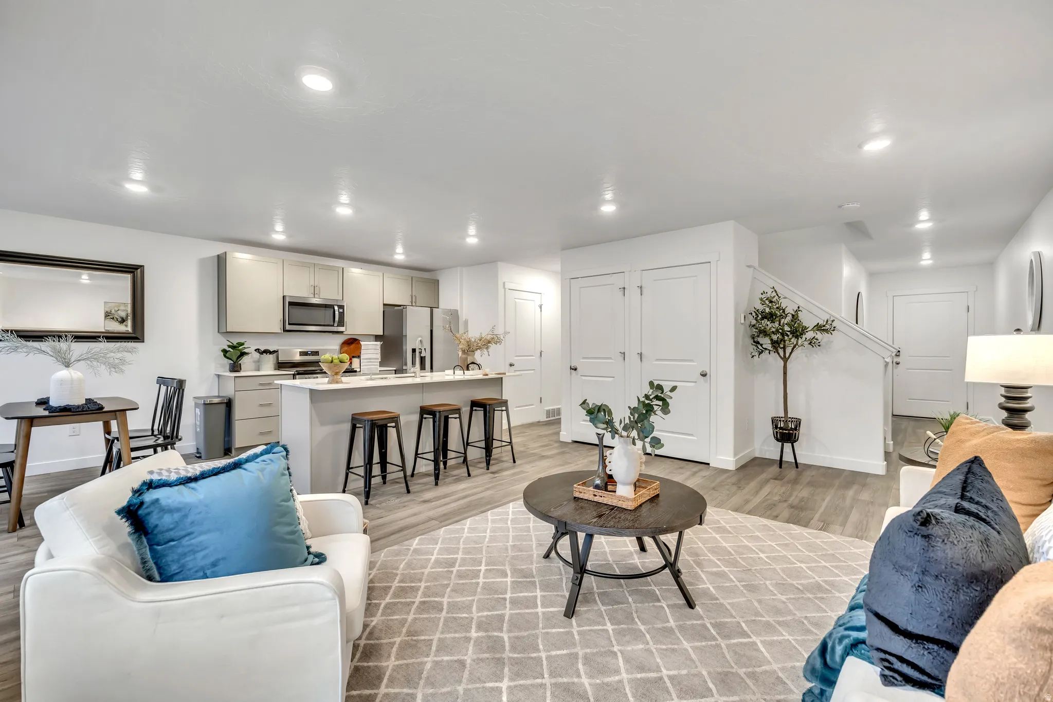 Living area featuring light wood finished floors and recessed lighting