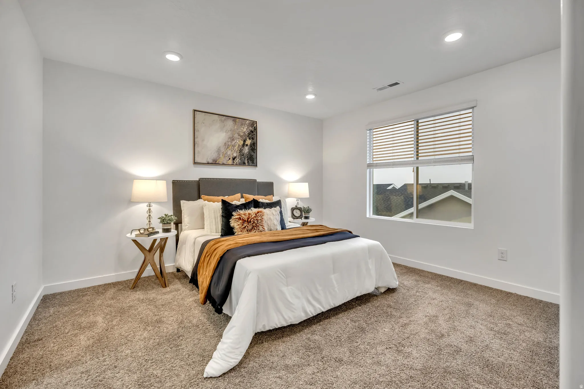 Carpeted master bedroom featuring baseboards and recessed lighting
