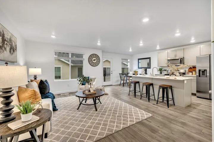 Living room with light wood finished floors and recessed lighting