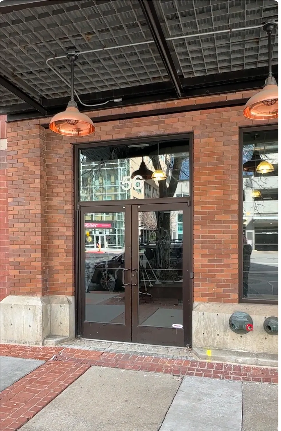Doorway to property with french doors and brick siding