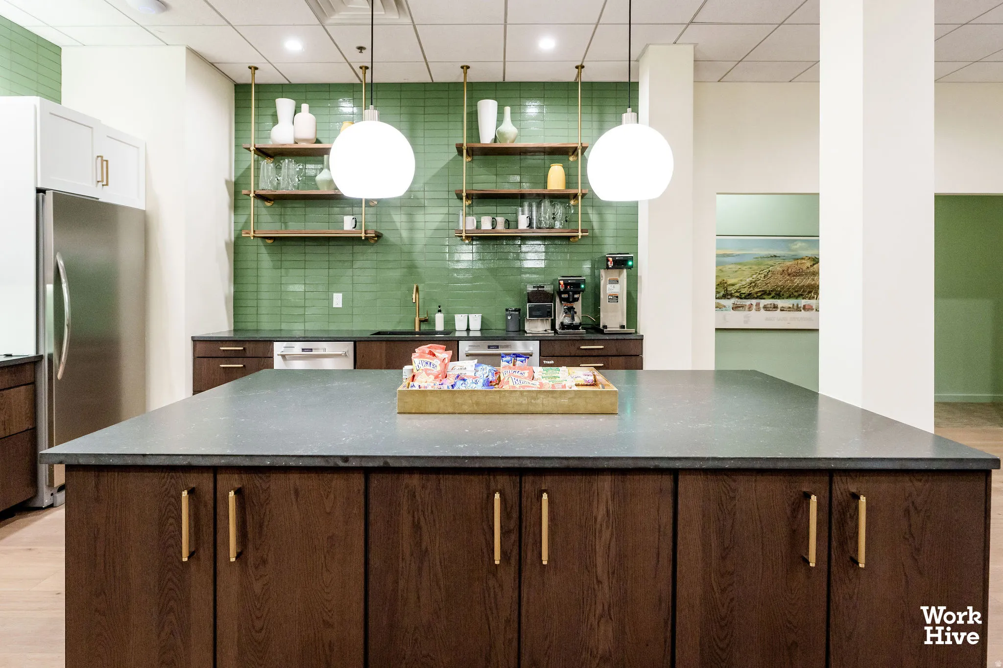 Bar area featuring a drop ceiling, freestanding refrigerator, open shelves, decorative light fixtures, and dark stone countertops