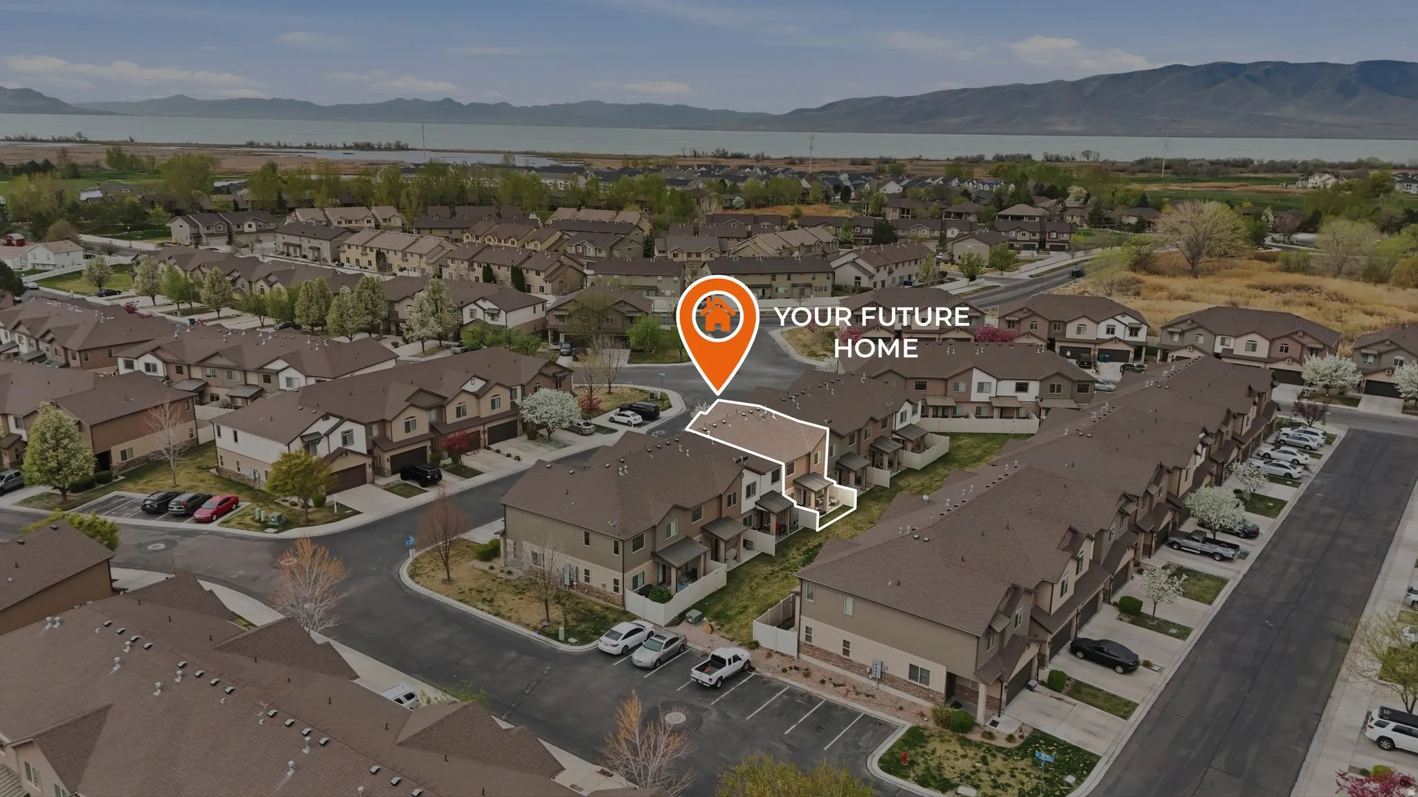 Aerial view of property and surrounding area featuring a water and mountain view