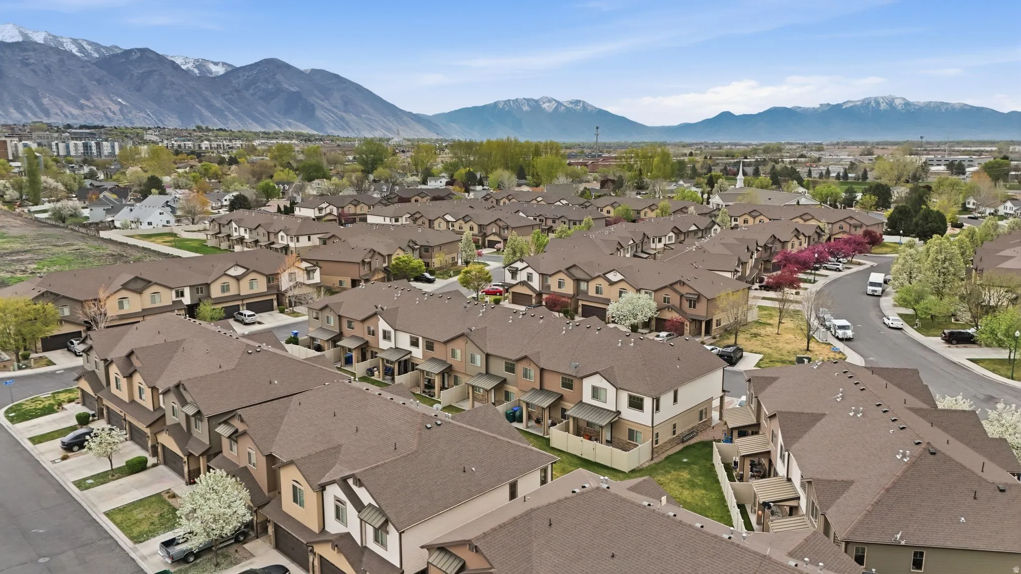 Aerial view of residential area featuring a mountainous background