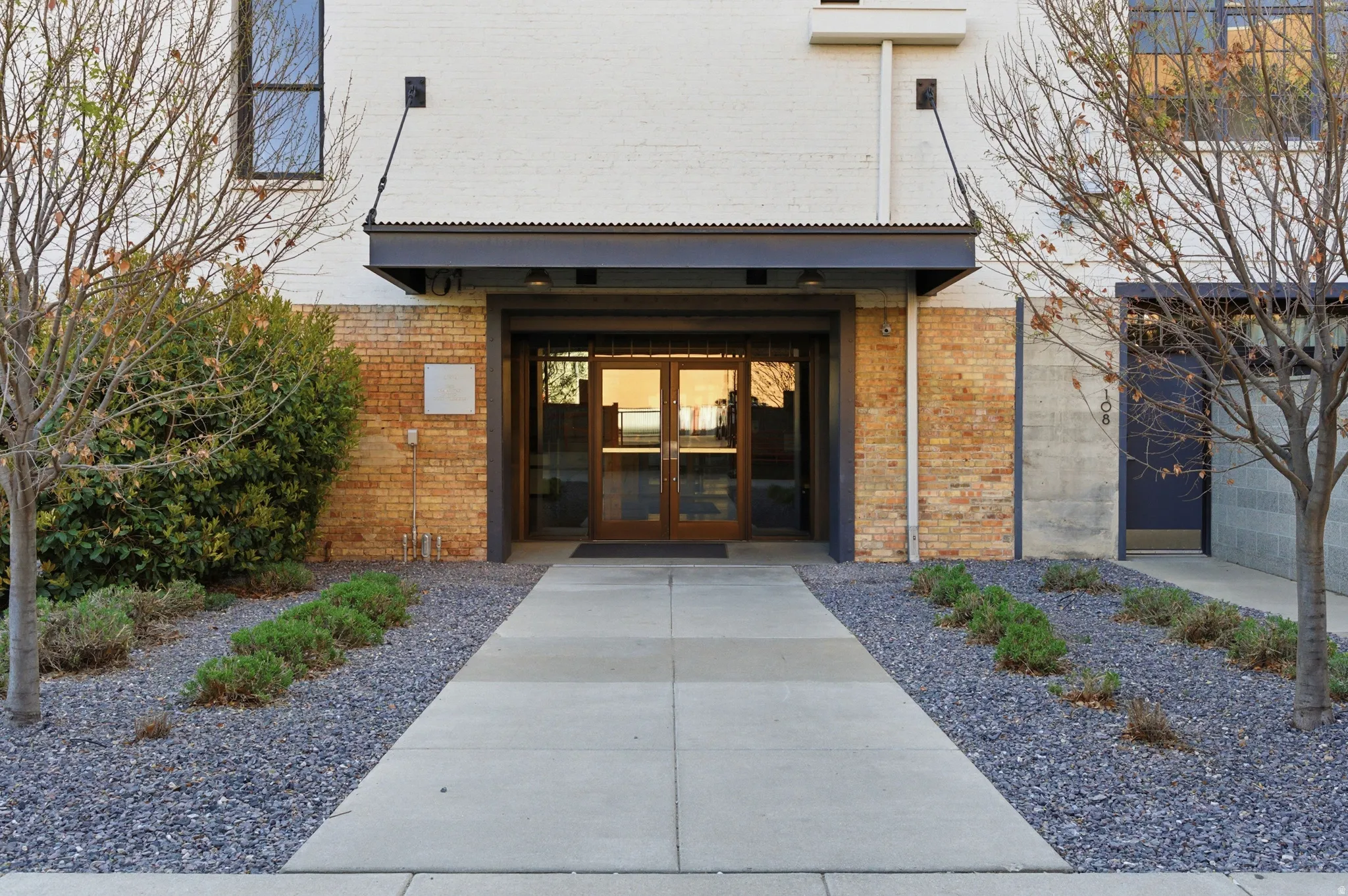 View of exterior entry with french doors and brick siding