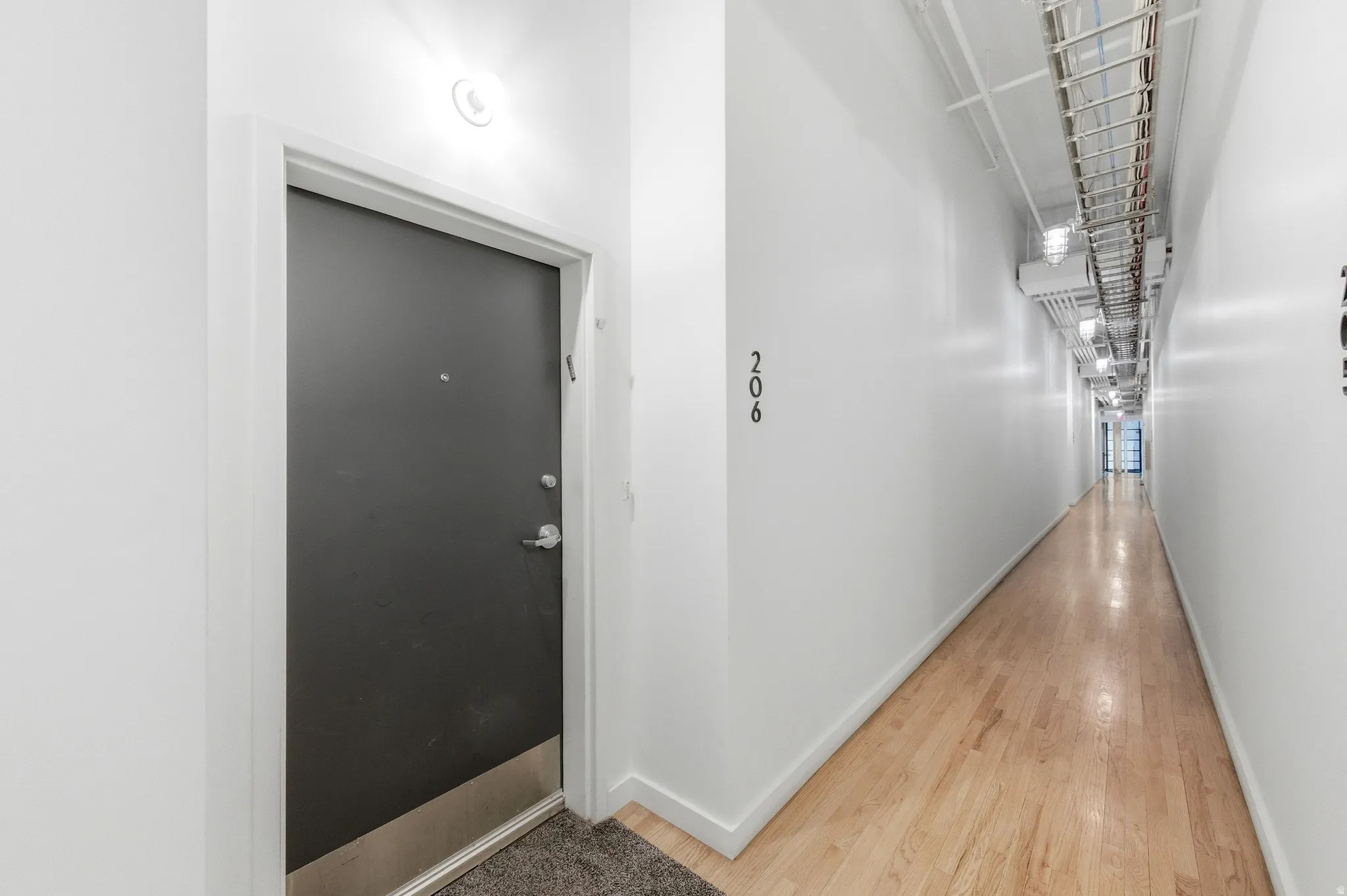 Hallway with light wood finished floors and baseboards