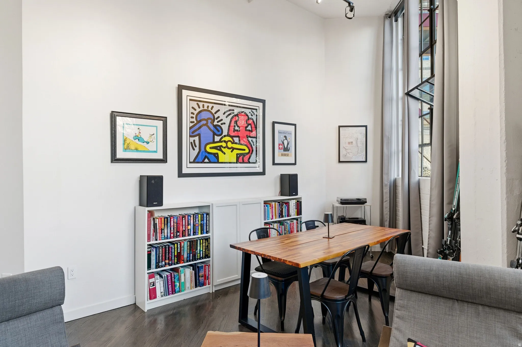 Dining room featuring dark wood-style flooring and baseboards