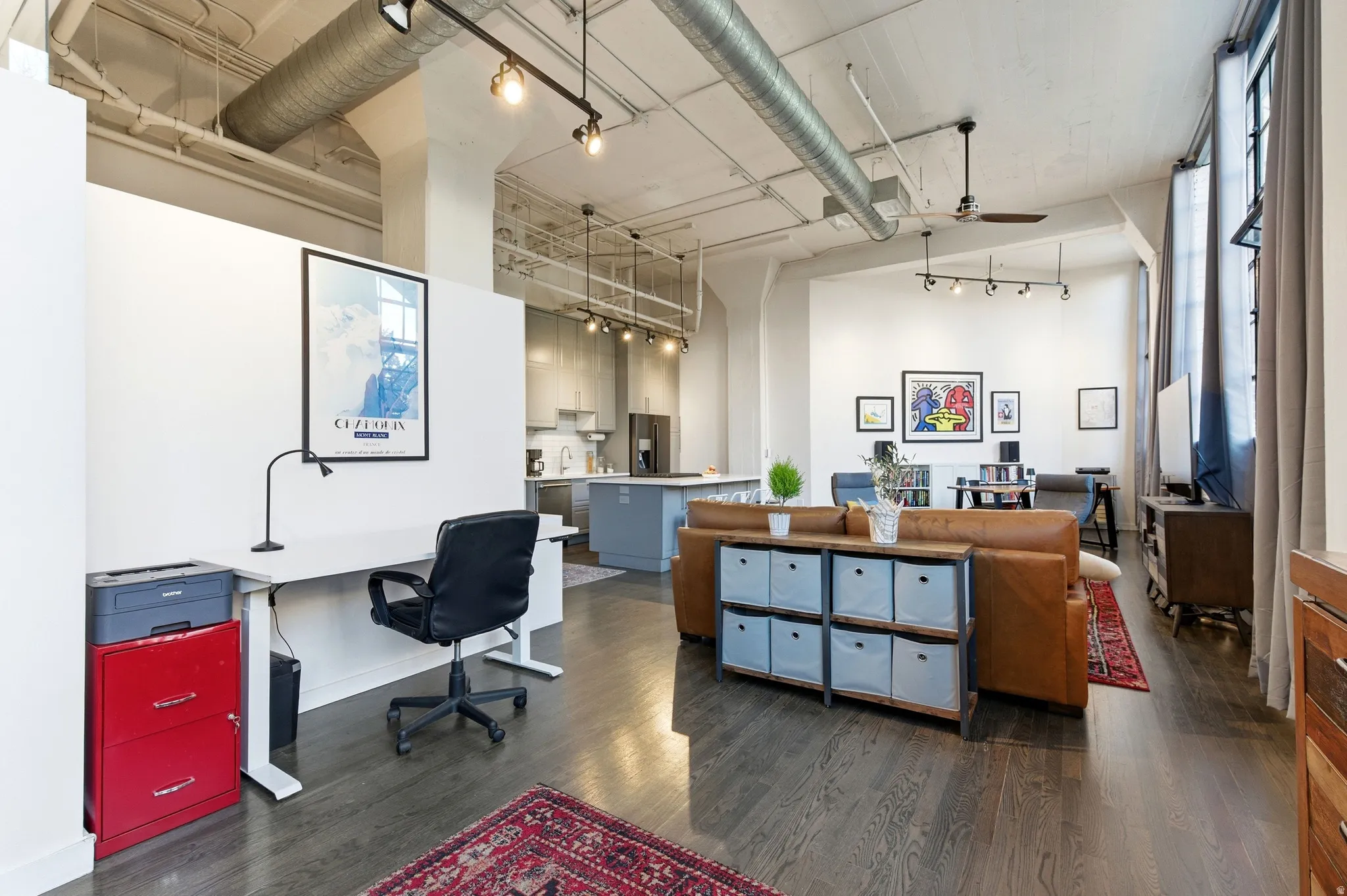 Home office with a ceiling fan, a high ceiling, and rail lighting