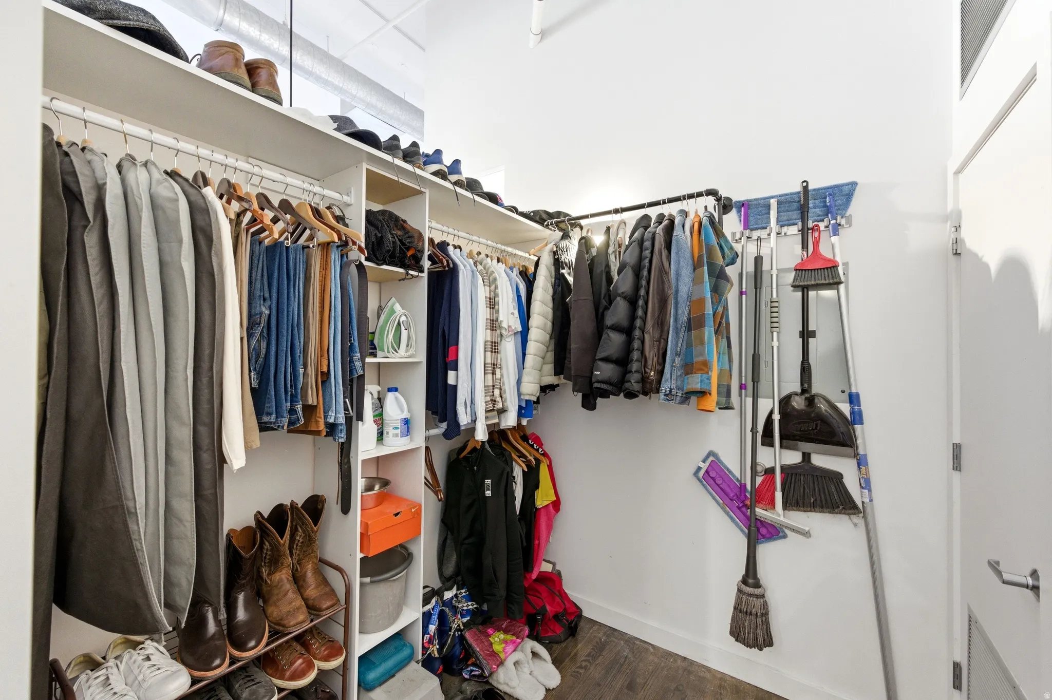 Walk in closet featuring dark wood-style floors