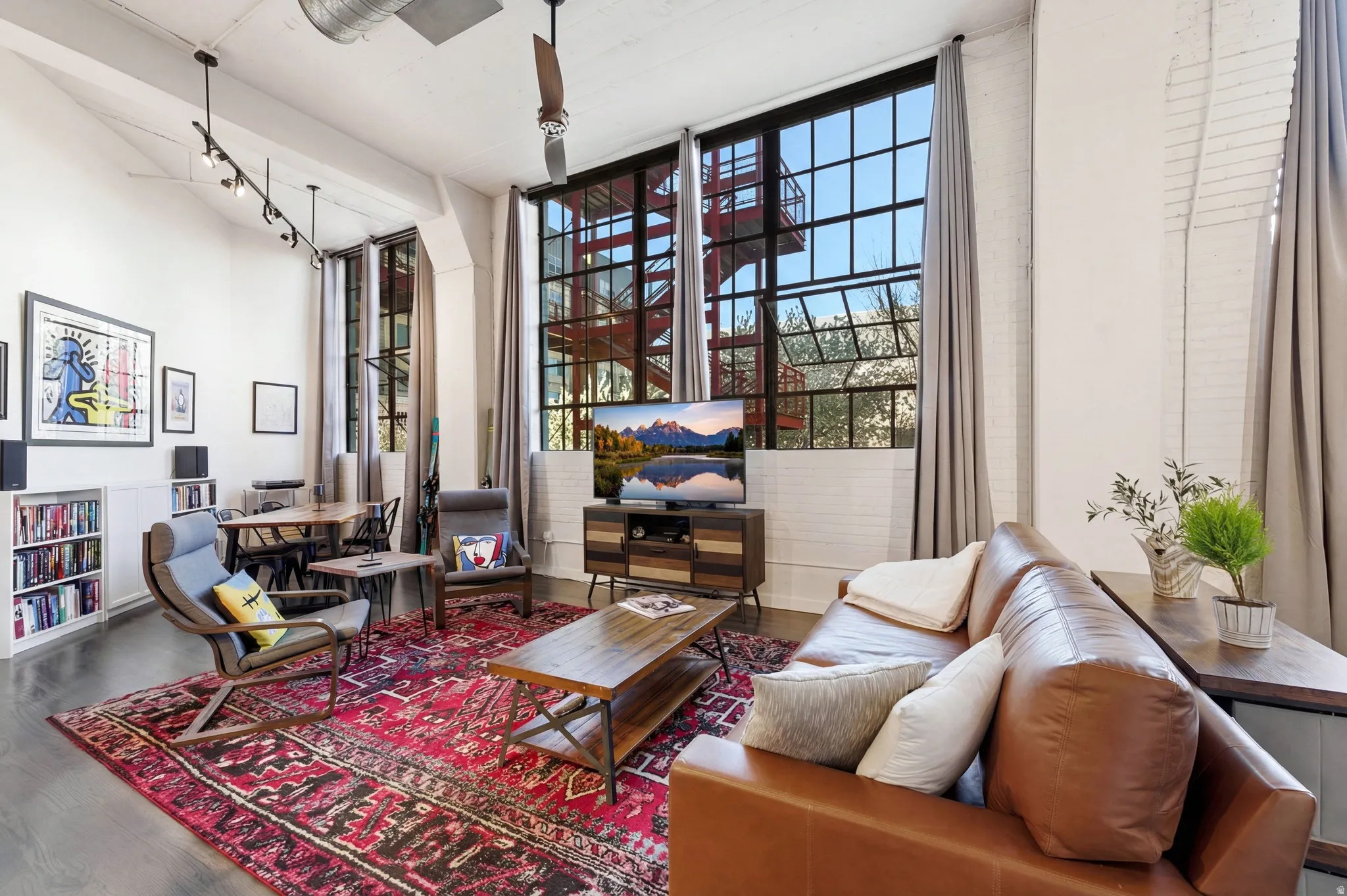 Sitting room featuring wood finished floors, expansive windows, and a high ceiling