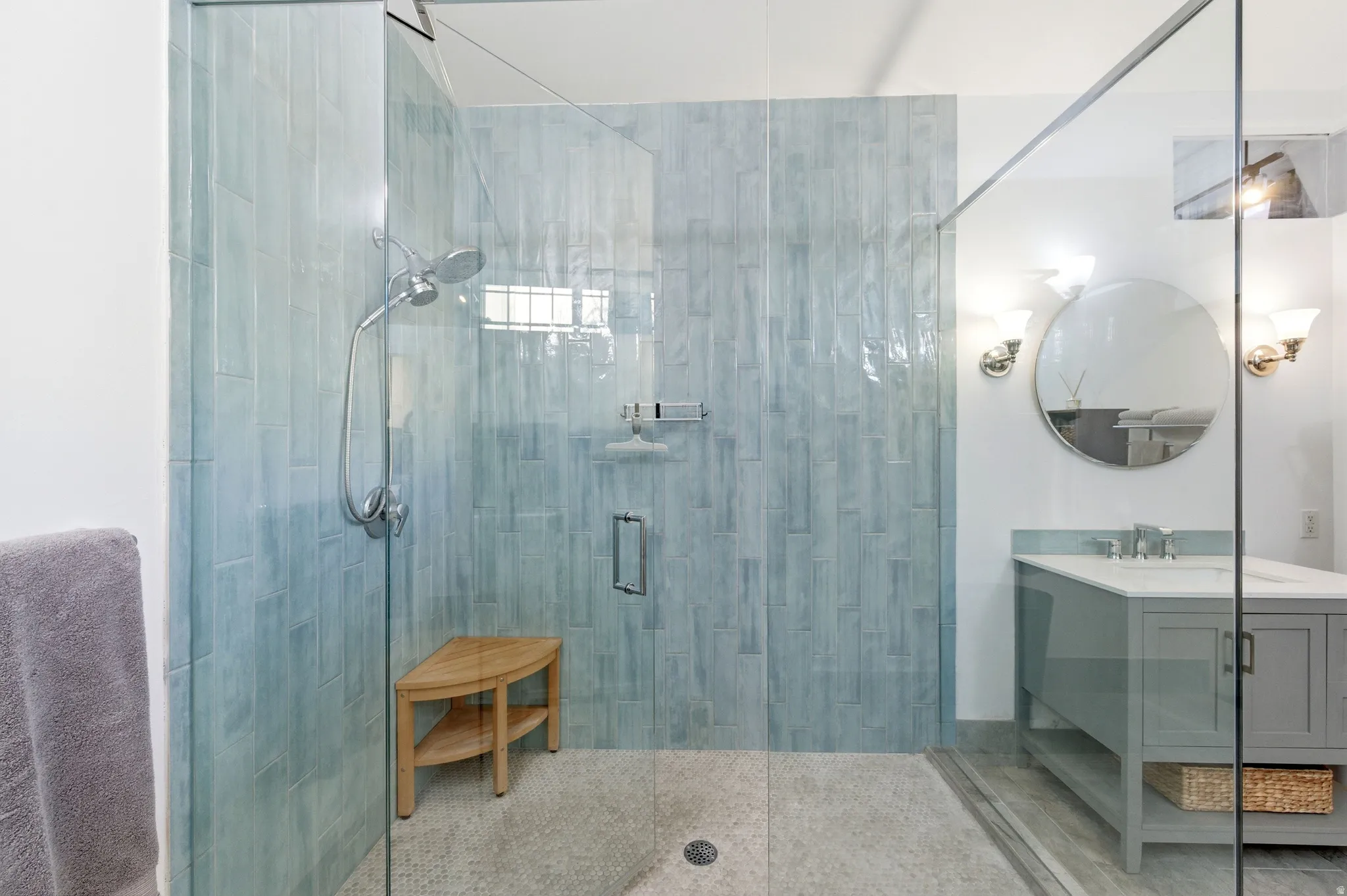 Bathroom featuring a shower stall and vanity