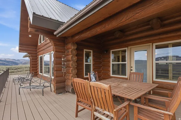 Wooden terrace with outdoor dining space and a mountain view