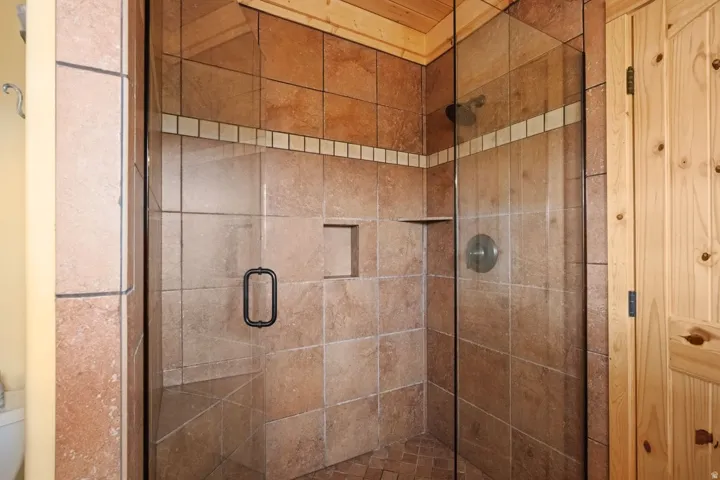 Full bath with a stall shower and toilet