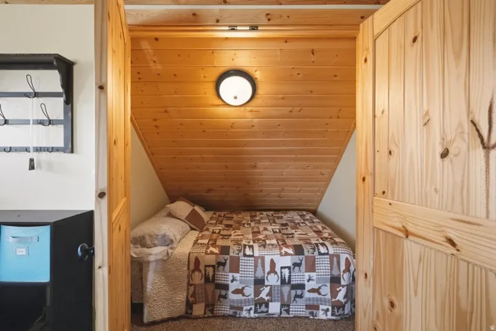 Bedroom with a vaulted wooden ceiling