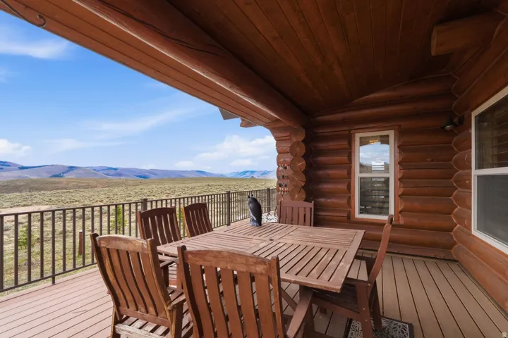 Wooden terrace with outdoor dining area and a mountain view