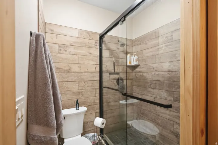 Bathroom featuring toilet and a stall shower