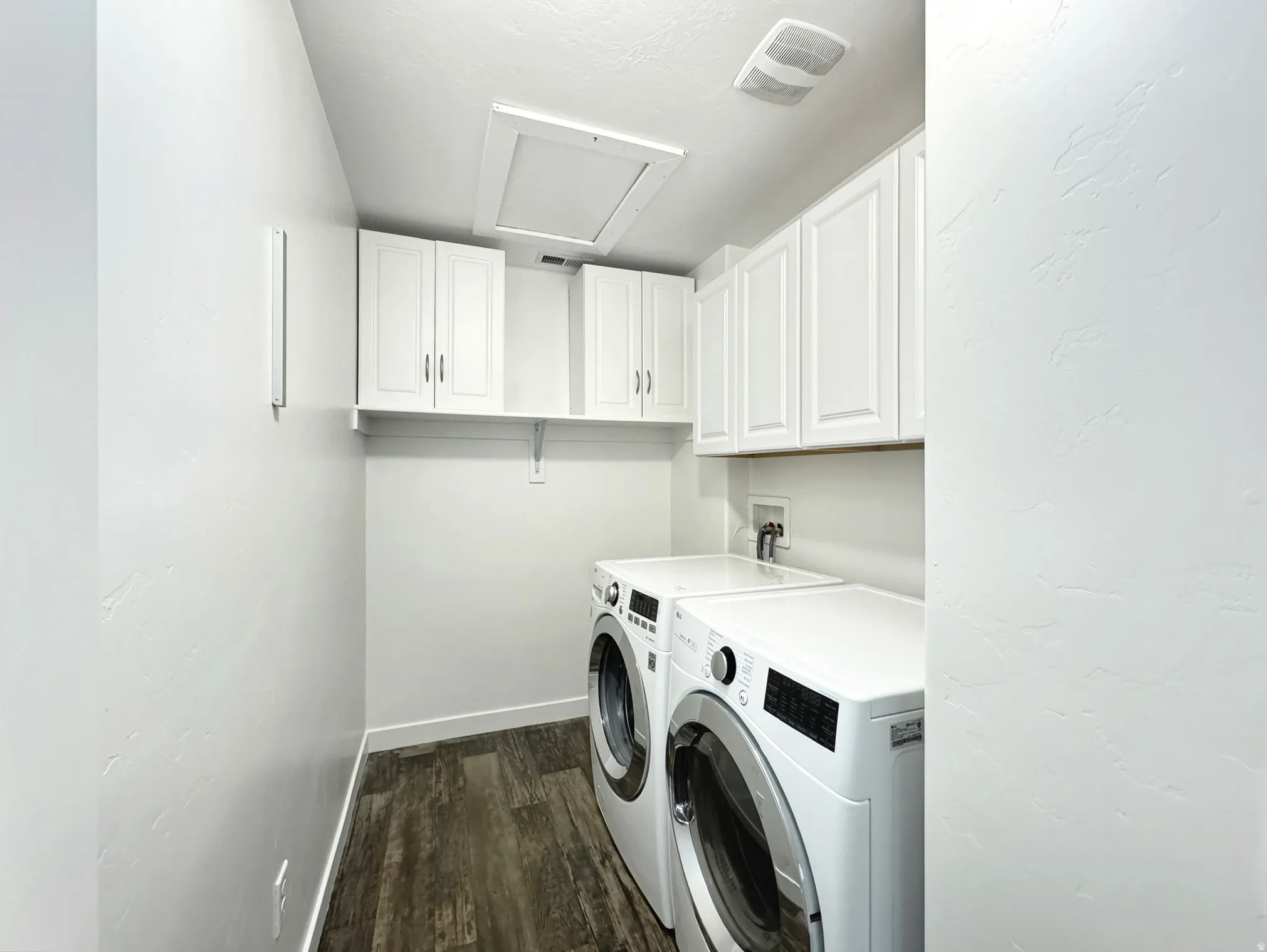 Upstairs laundry with washer and dryer.