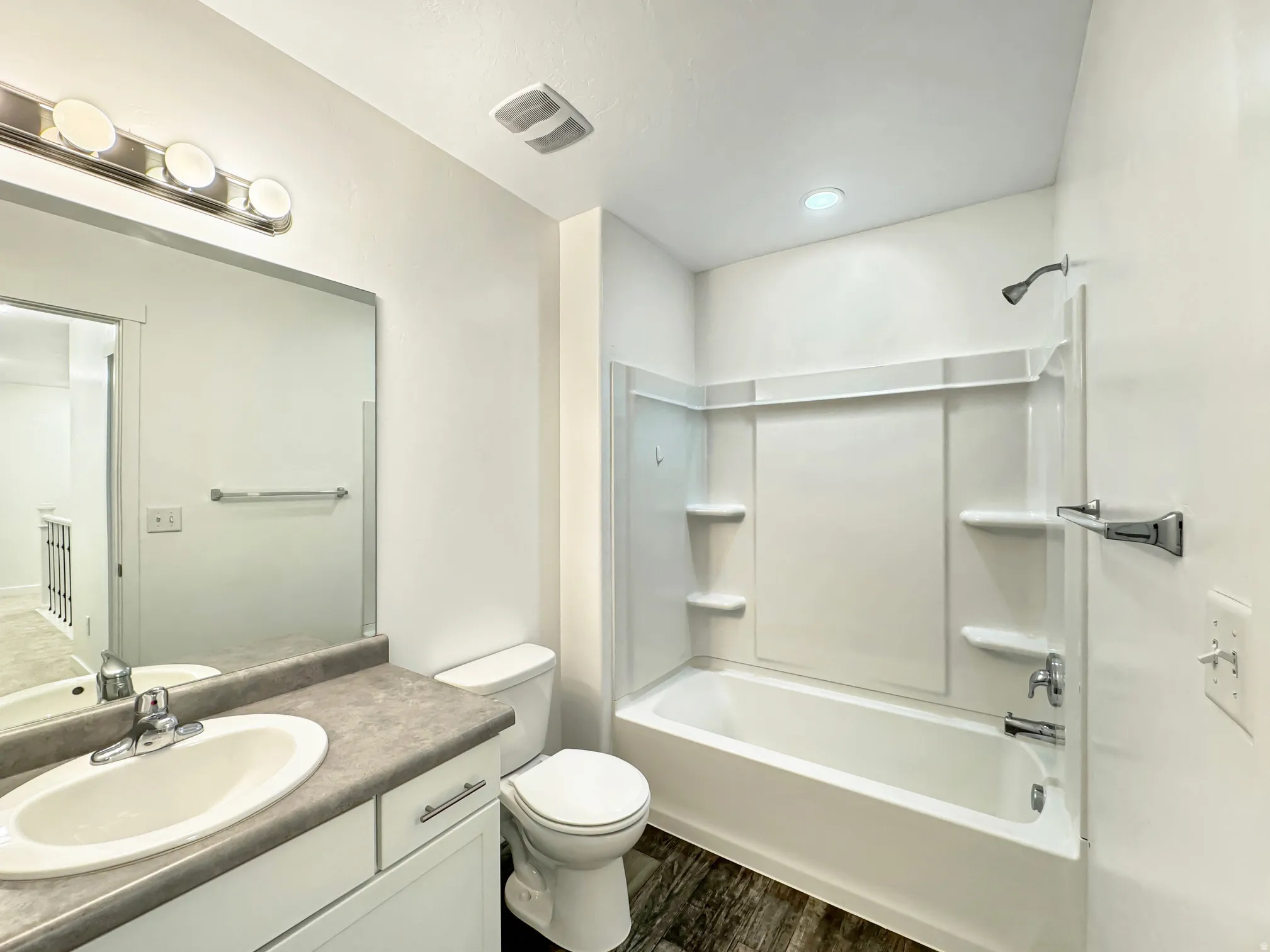 Upstairs Full bath with vanity, shower/tub combination, and dark wood-style flooring